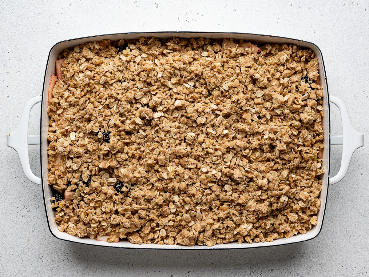 Unbaked assembled crumble in baking dish.