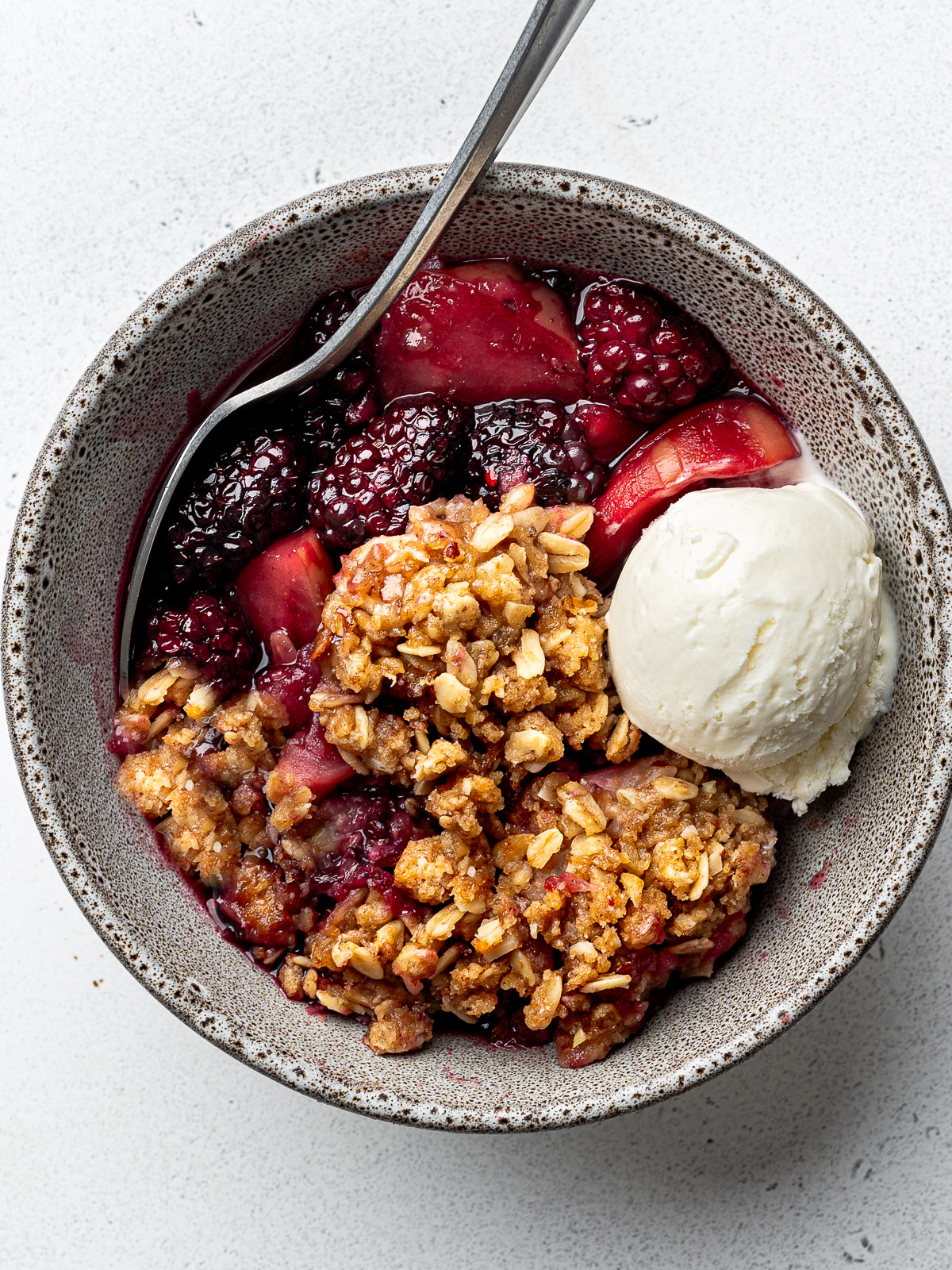 Crumble served in small bowl with ice cream.