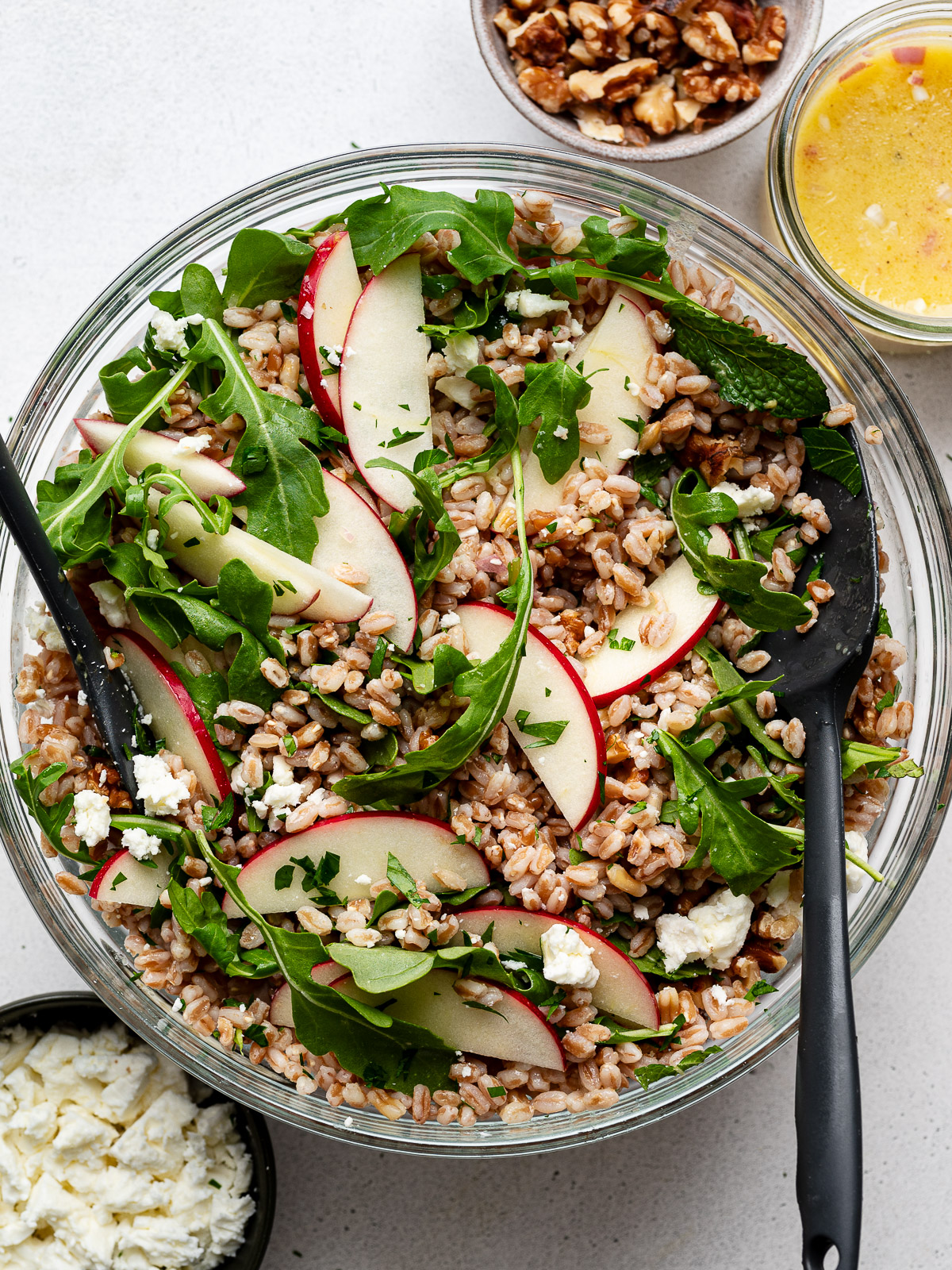 Farro salad tossed in glass mixing bowl.