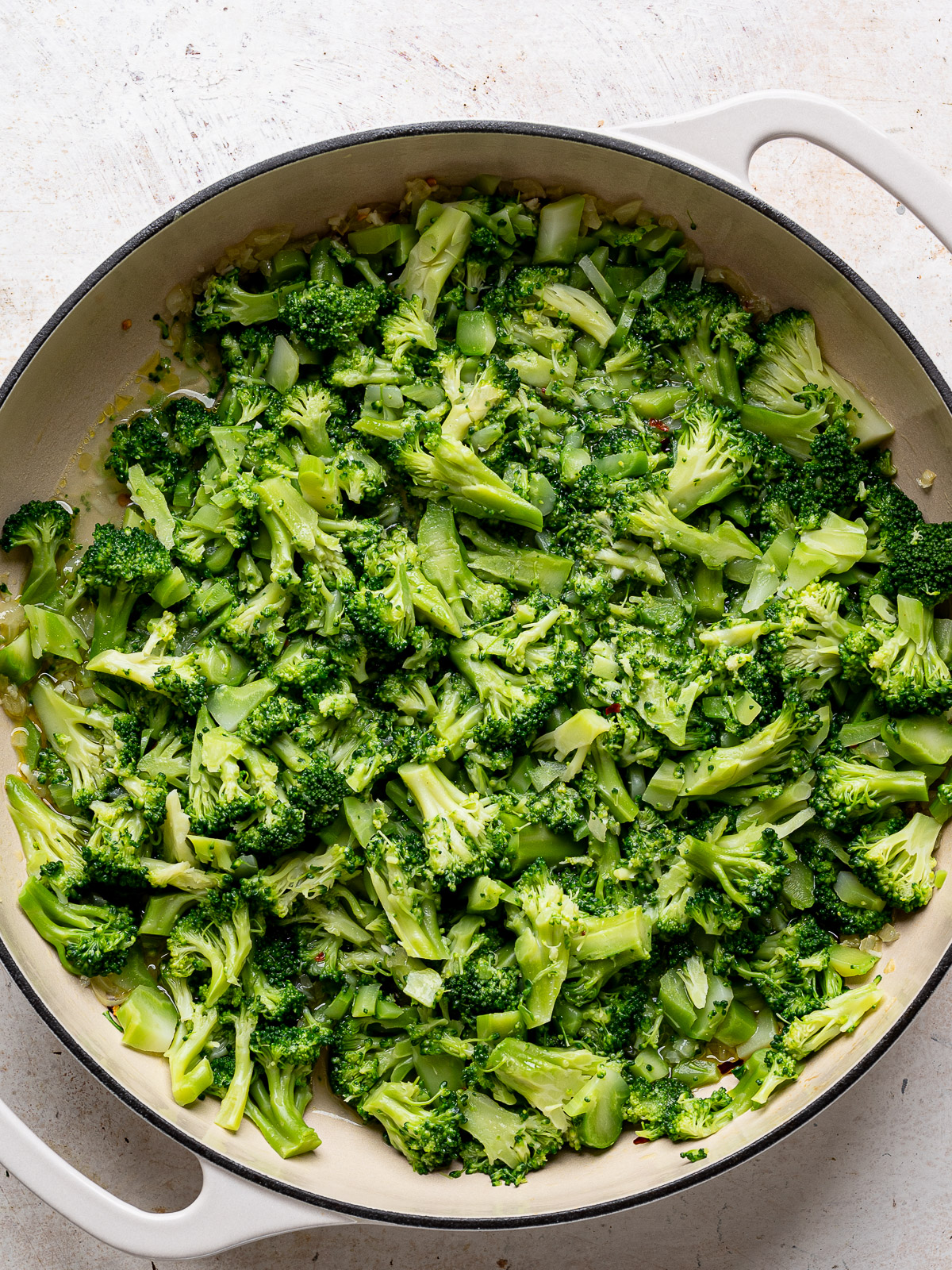 Boiled broccoli florets in skillet.