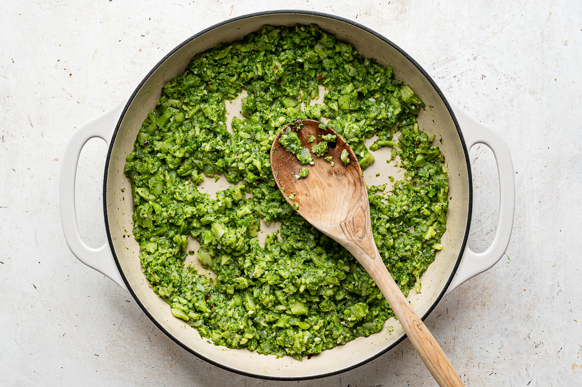 Smashed broccoli florets in skillet. 