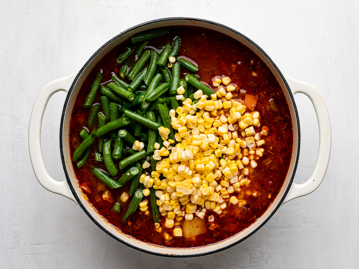 Green beans and corn kernels added to the soup. 