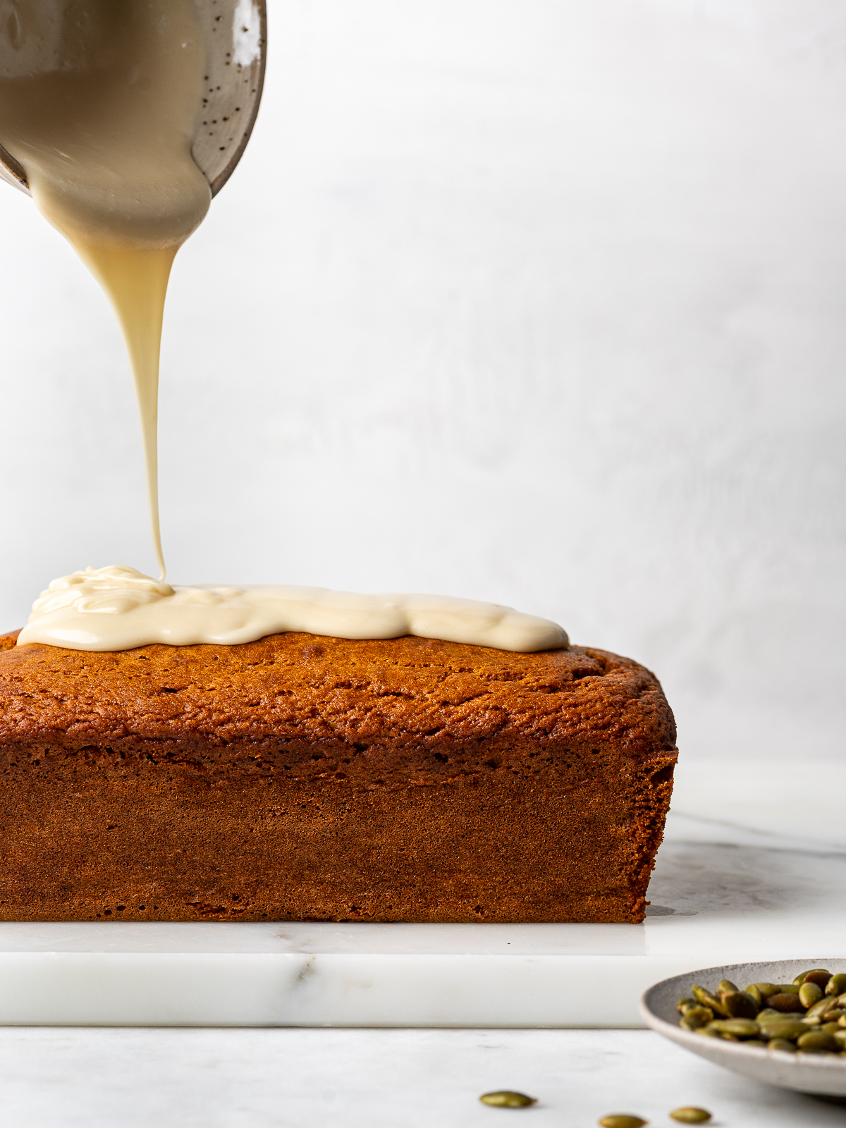 Pouring glaze over baked loaf.