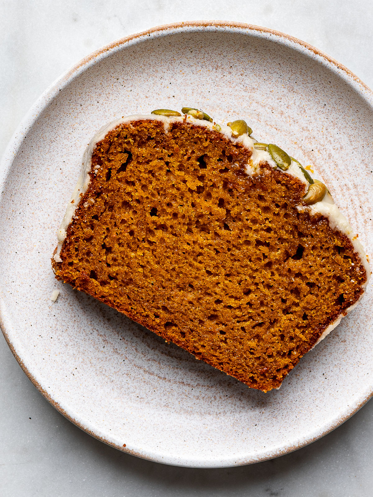 One slice of pumpkin loaf on plate. 
