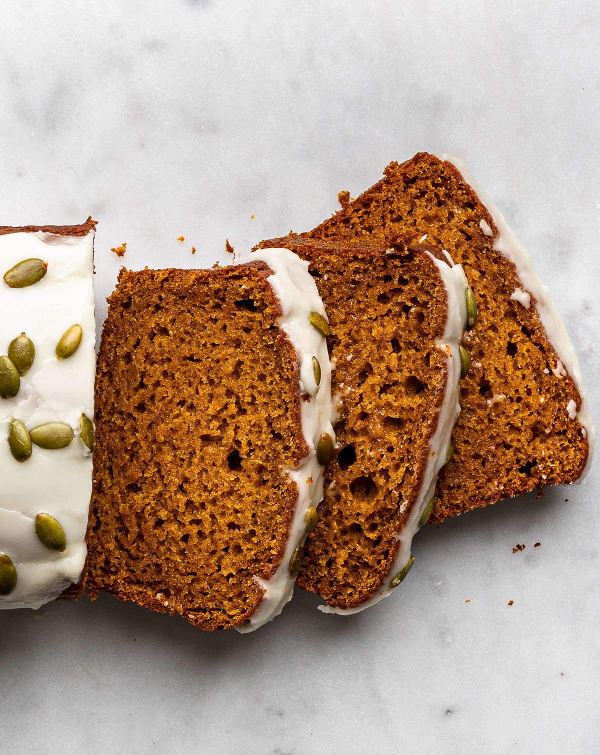 Sliced glazed gluten-free pumpkin loaf.