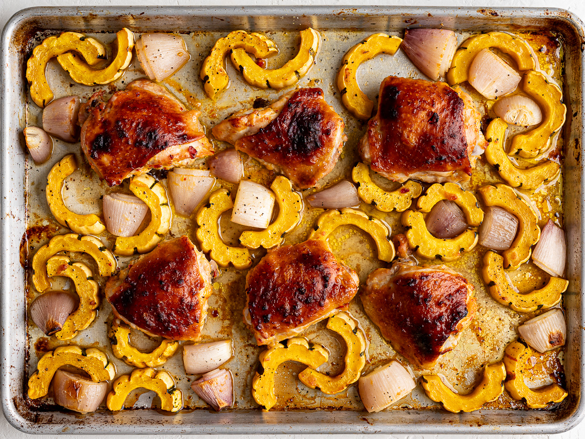Roasted miso-honey chicken with delicata squash on sheet pan. 