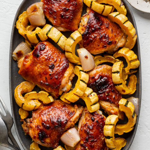 Miso-Honey Chicken with delicate squash served on a dark grey platter.
