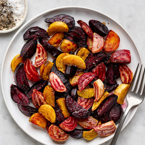 Air fryer beets served on a white platter with serving fork.