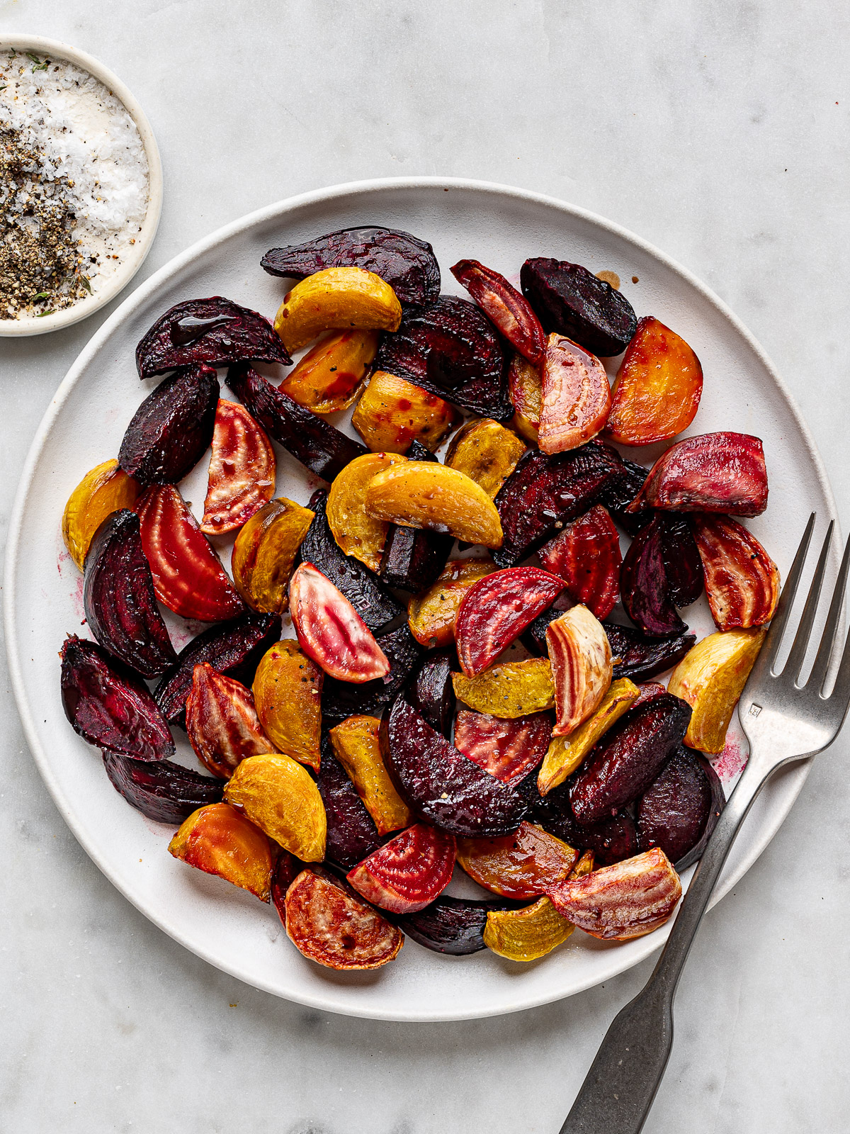 Air fryer beets served on a white platter with serving fork.