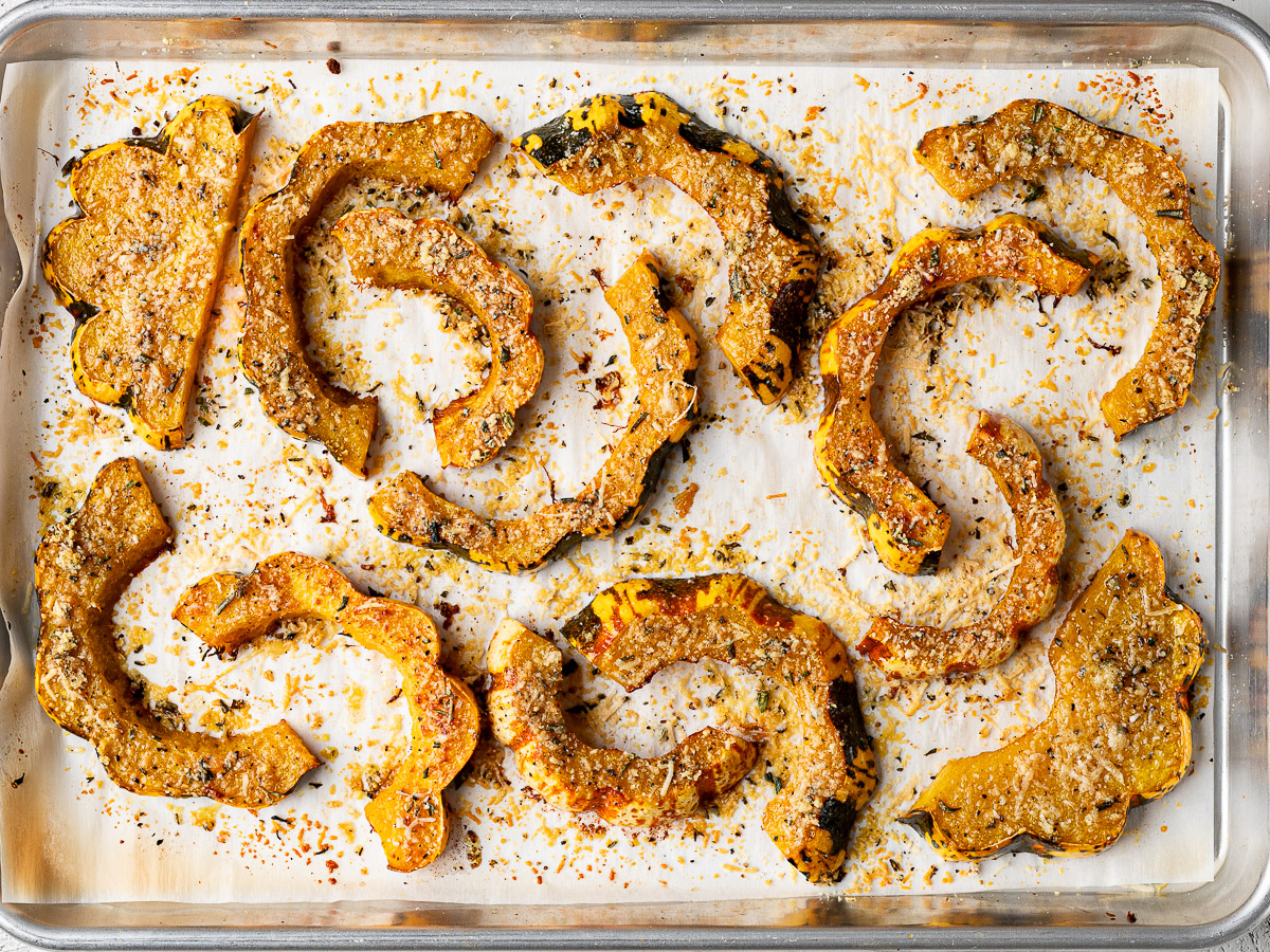 Roasted squash slices on baking sheet.