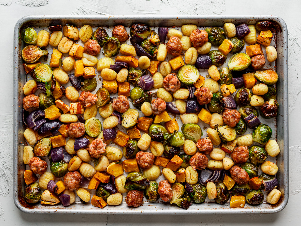Roasted gnocchi, Brussels sprouts, squash and red onion on a sheet pan. 
