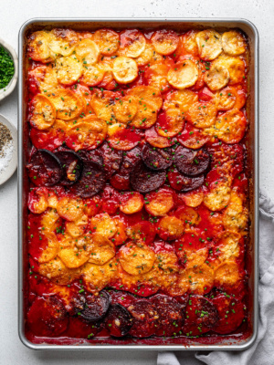 Baked Sheet pan root vegetable gratin garnished with chopped chives.
