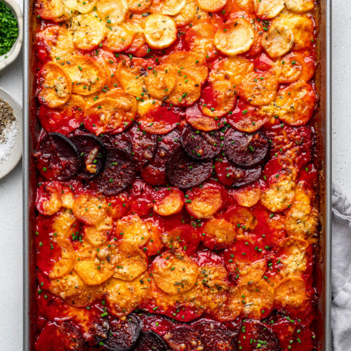 Baked Sheet pan root vegetable gratin garnished with chopped chives.