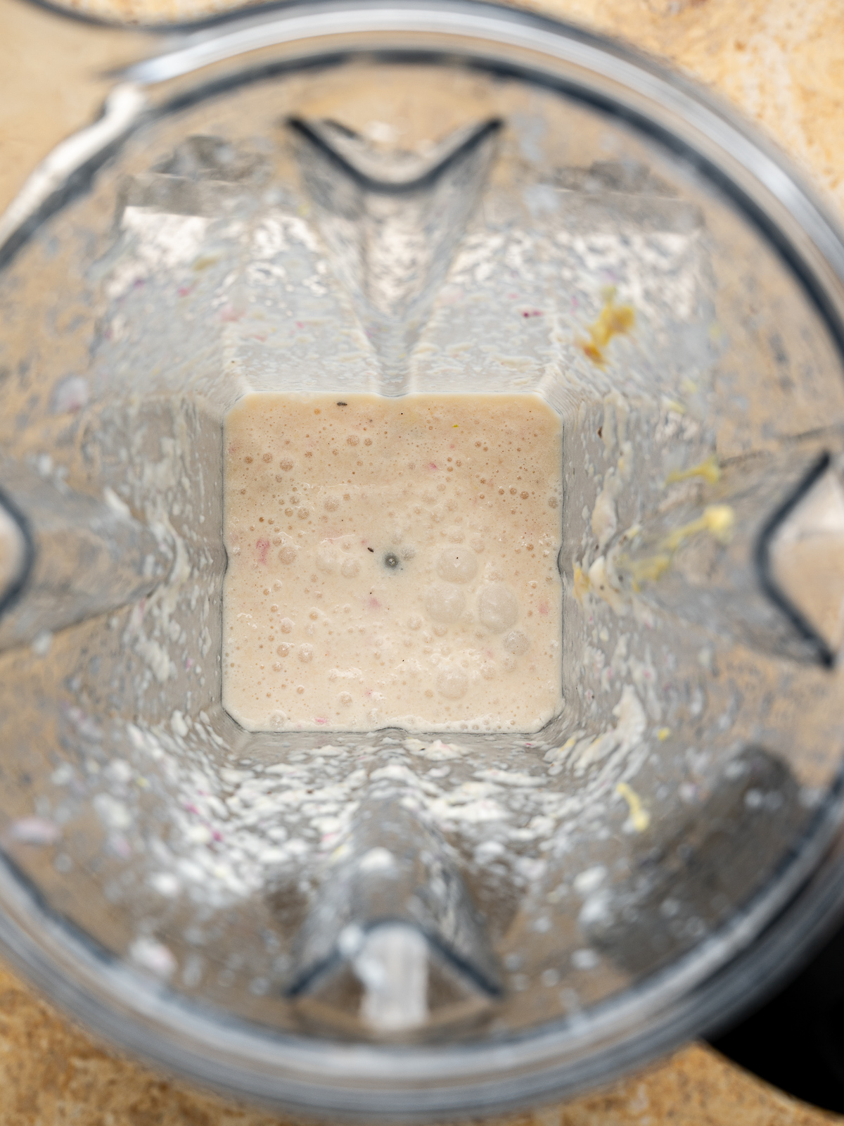 Close up of blended vinaigrette ingredients before adding olive oil in blender jar. 