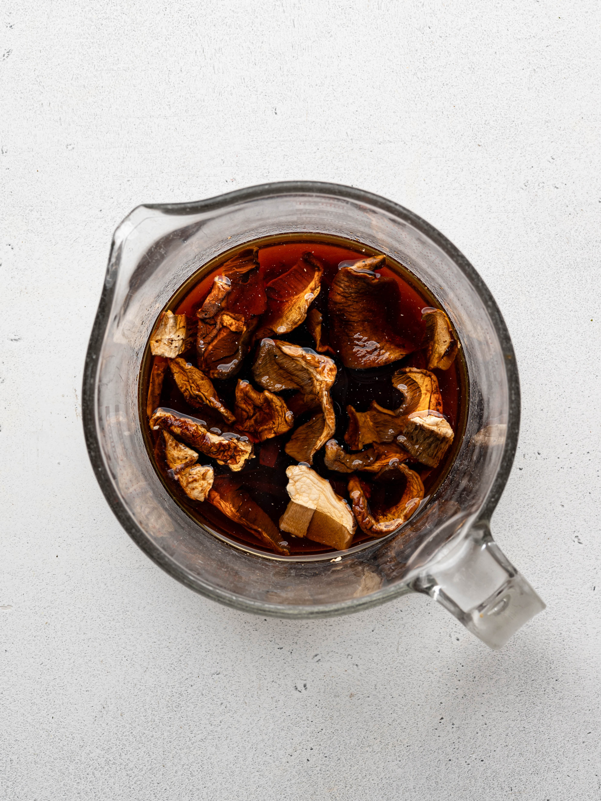 Dried porcini mushrooms soaking in warm water. 