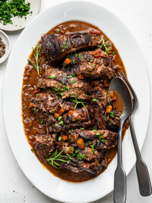 Sliced Stracatto di manzo (Italian pot roast) served on a large white platter.