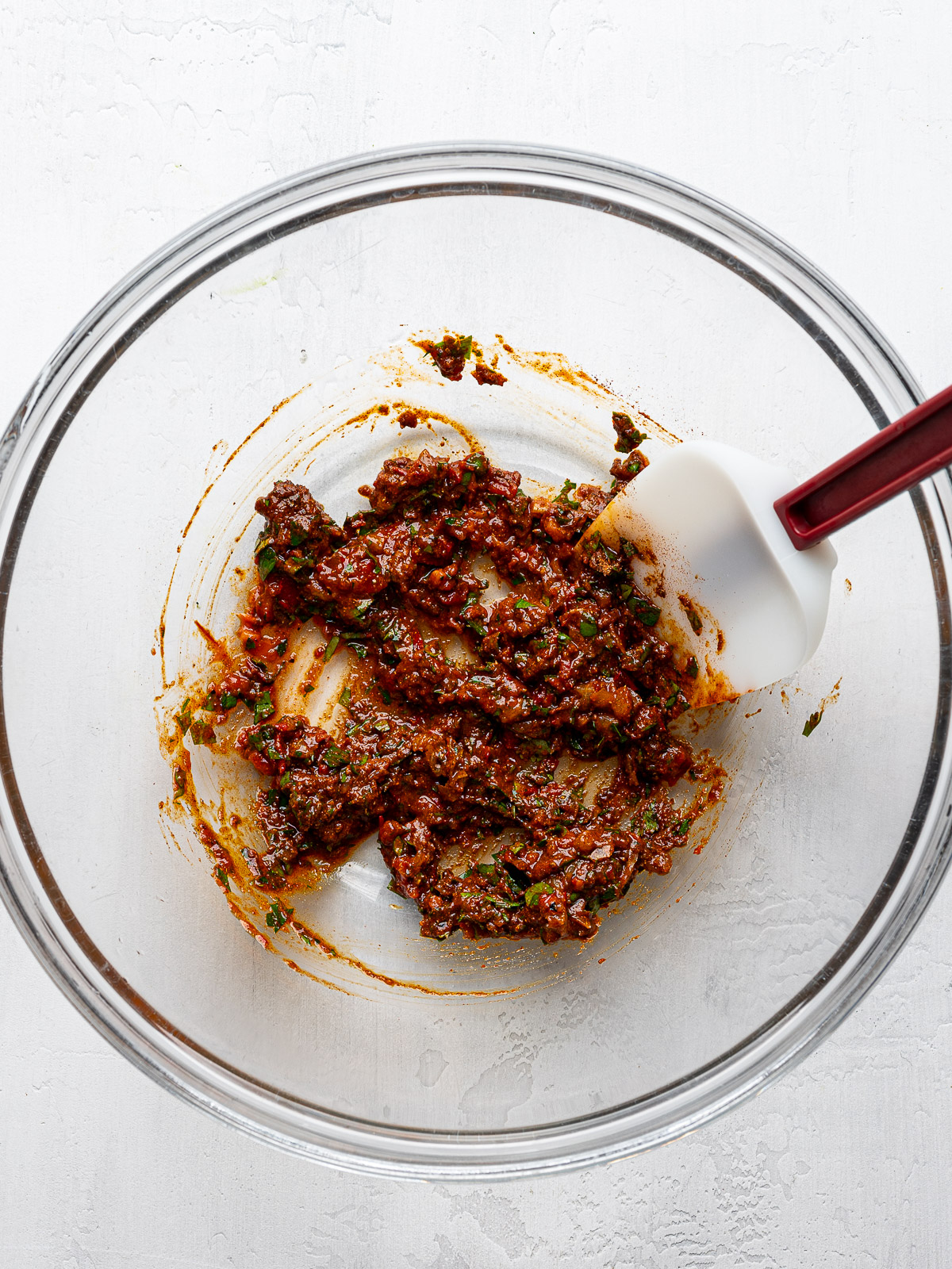 Marinade for chicken in a glass mixing bowl.