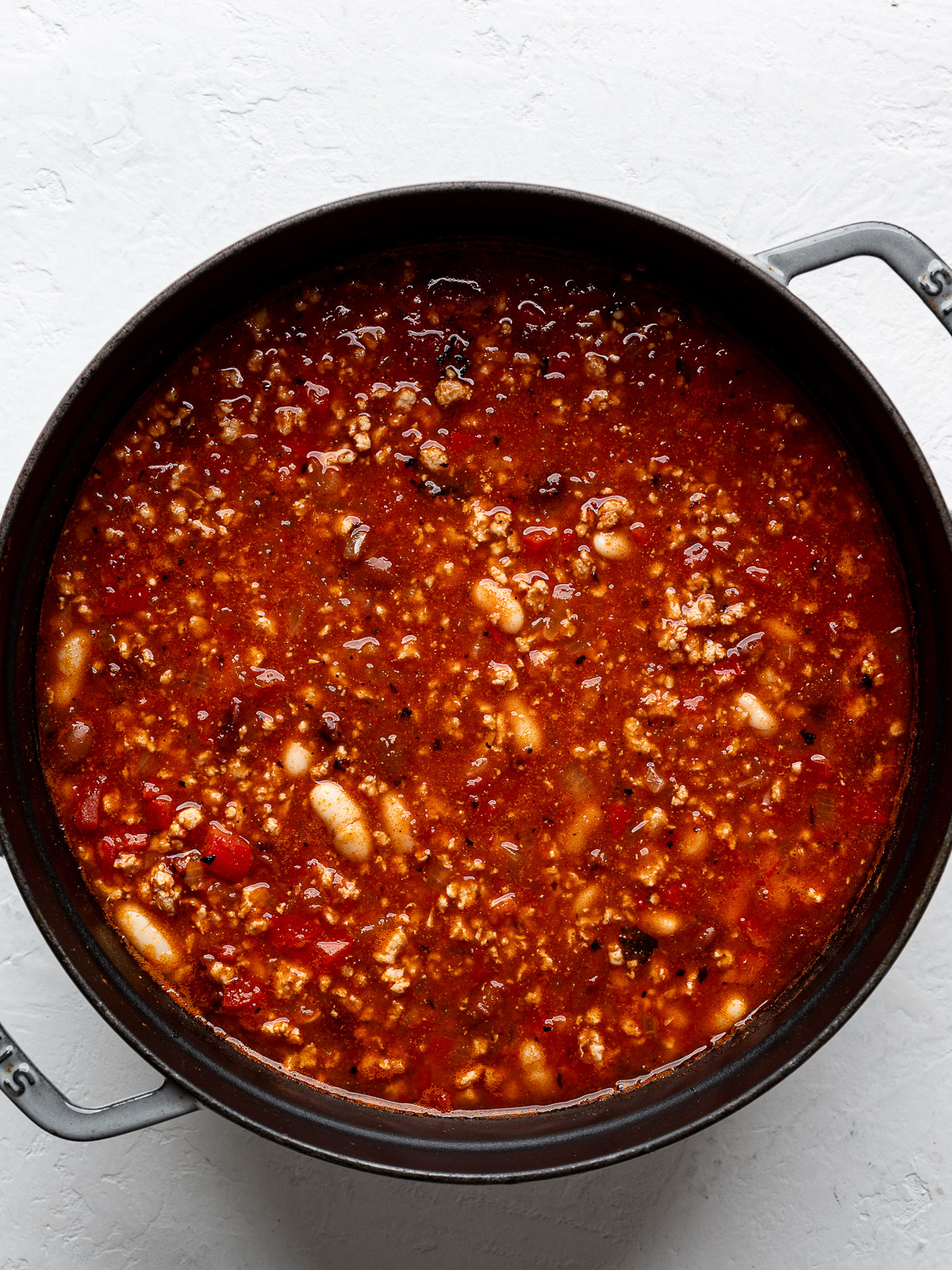 All of the chili ingredients in Dutch oven before getting cooked.