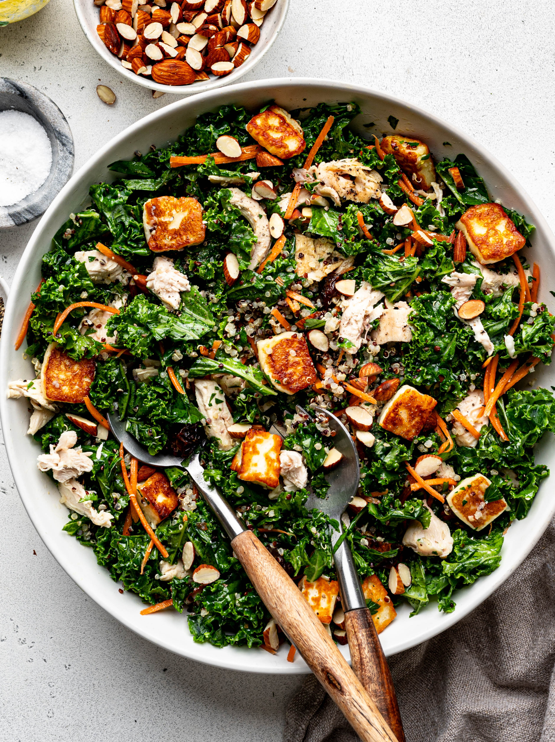 Kale and quinoa salad tossed with dressing. 