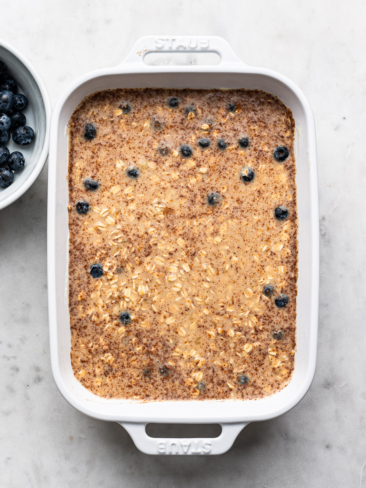 Remaining oat mixture poured over blueberries in baking dish. 