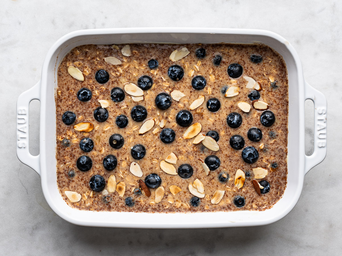 Un-baked oat mixture topped  with remaining blueberries and sliced almonds.