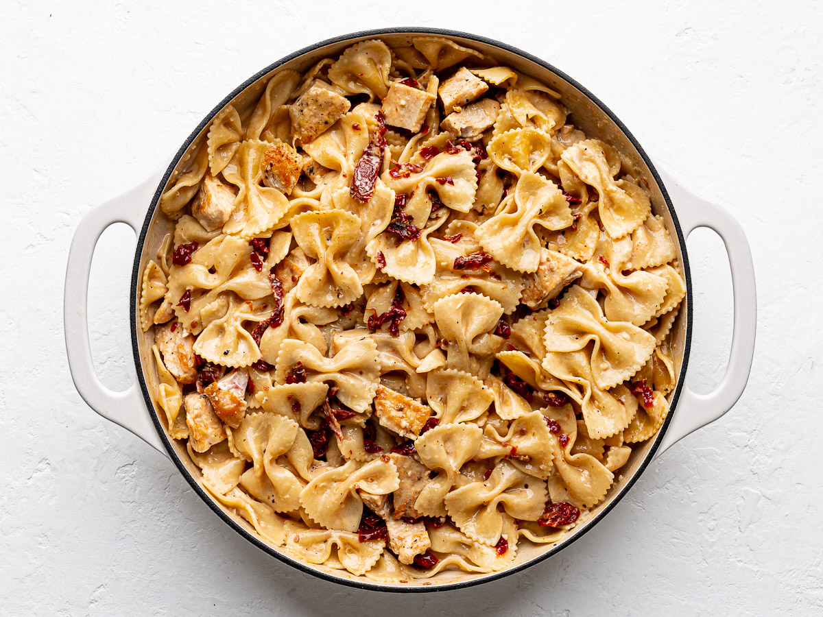 The finished dish of marry me chicken pasta in a large white skillet.