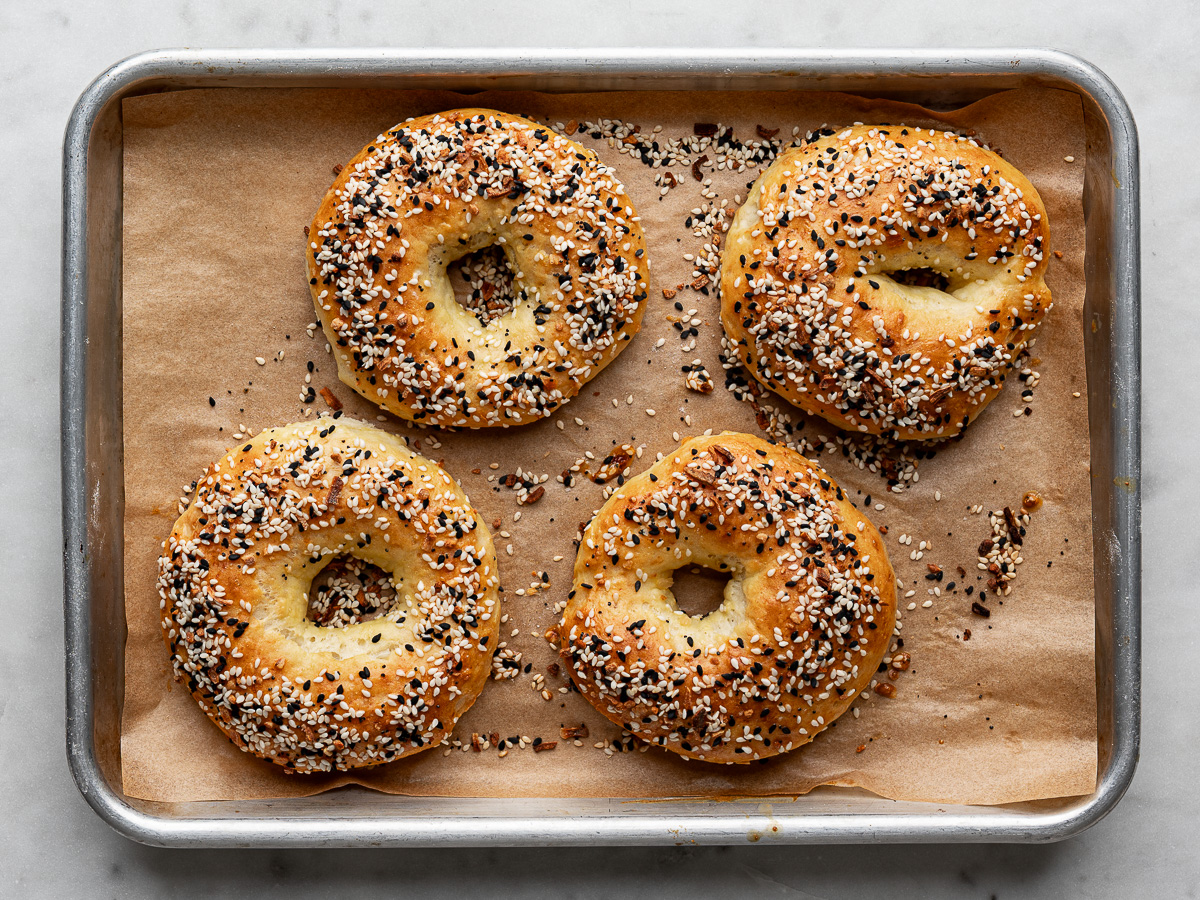4 baked bagels on baking sheet. 