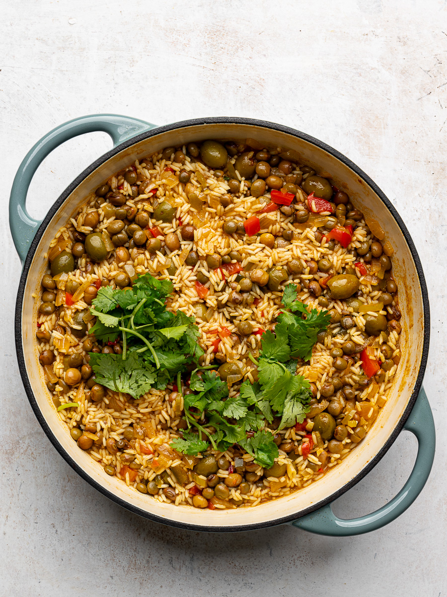Rice partially cooked in pot with chopped cilantro.