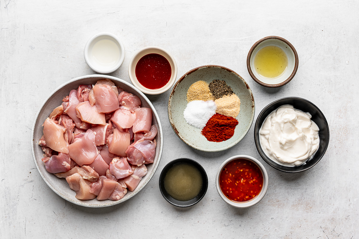 Recipe ingredients prepared in small bowls.