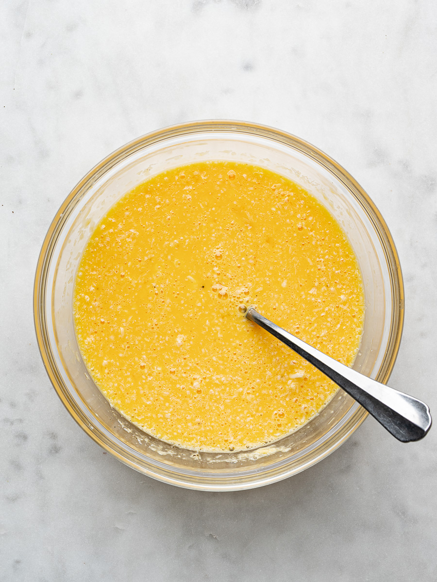 Egg mixture combined in glass mixing bowl. 