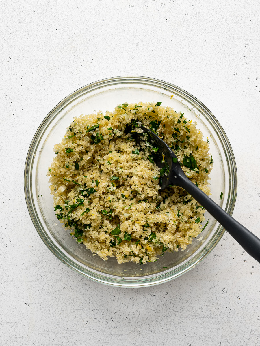 Buttery panko mixture in small glass bowl. 