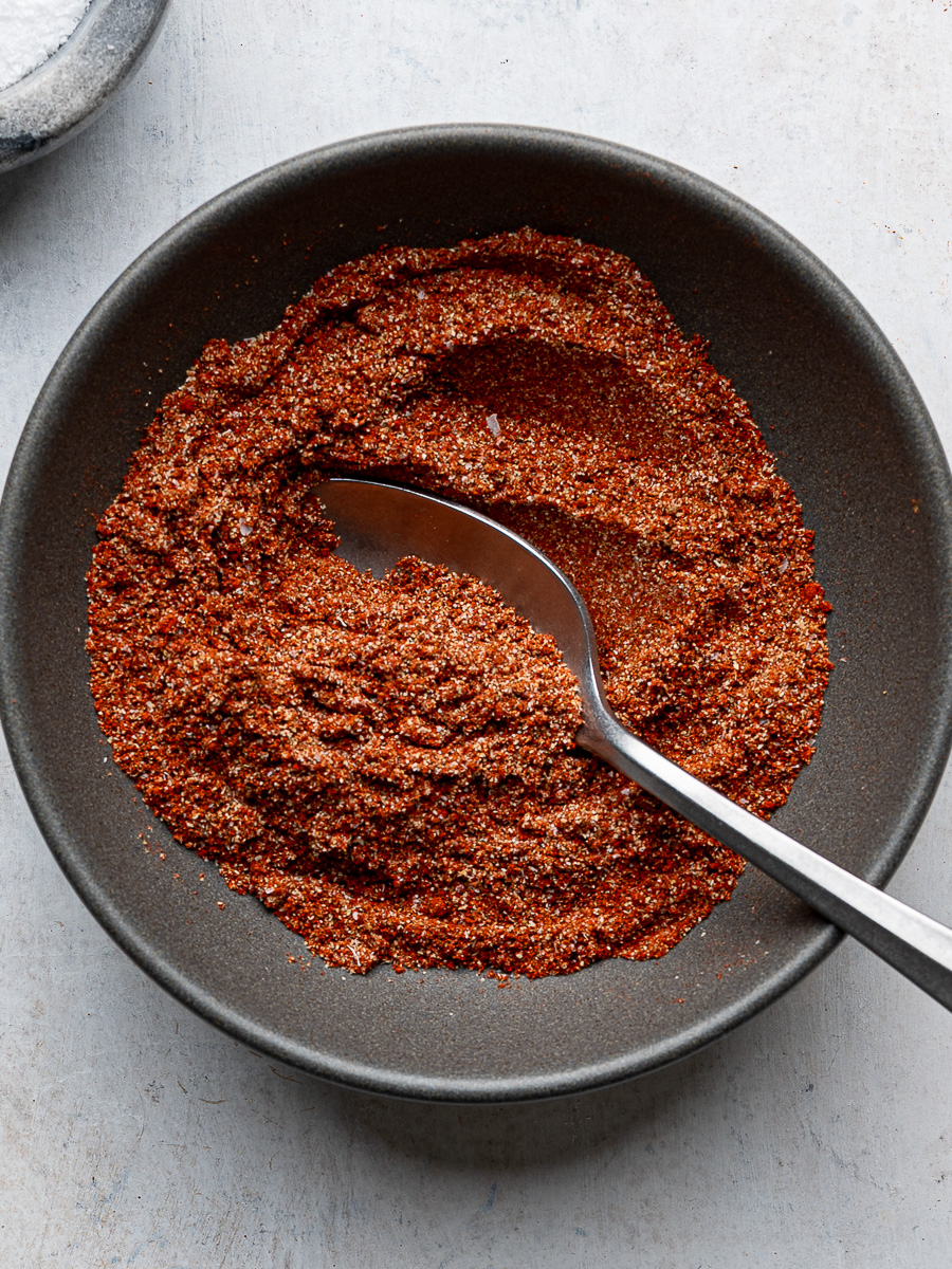 Sazón seasoning combined in a dark grey bowl.