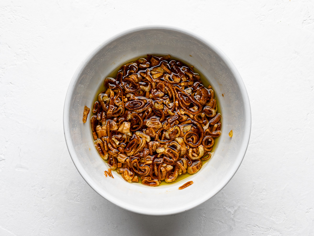 Crispy fried shallots in small white bowl that were "fried" in the microwave. 