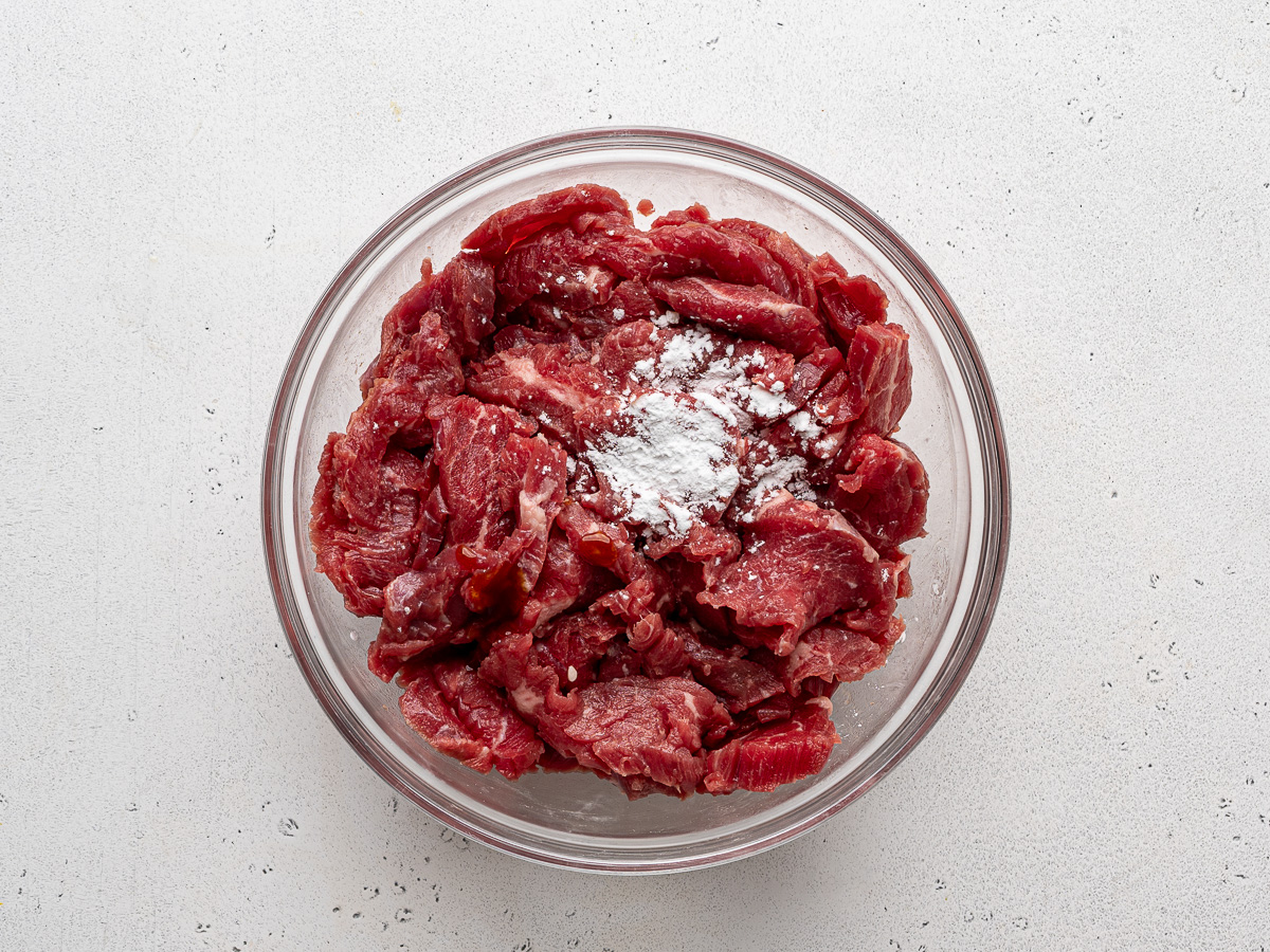 Sliced beef tossed with baking soda and cornstarch. 