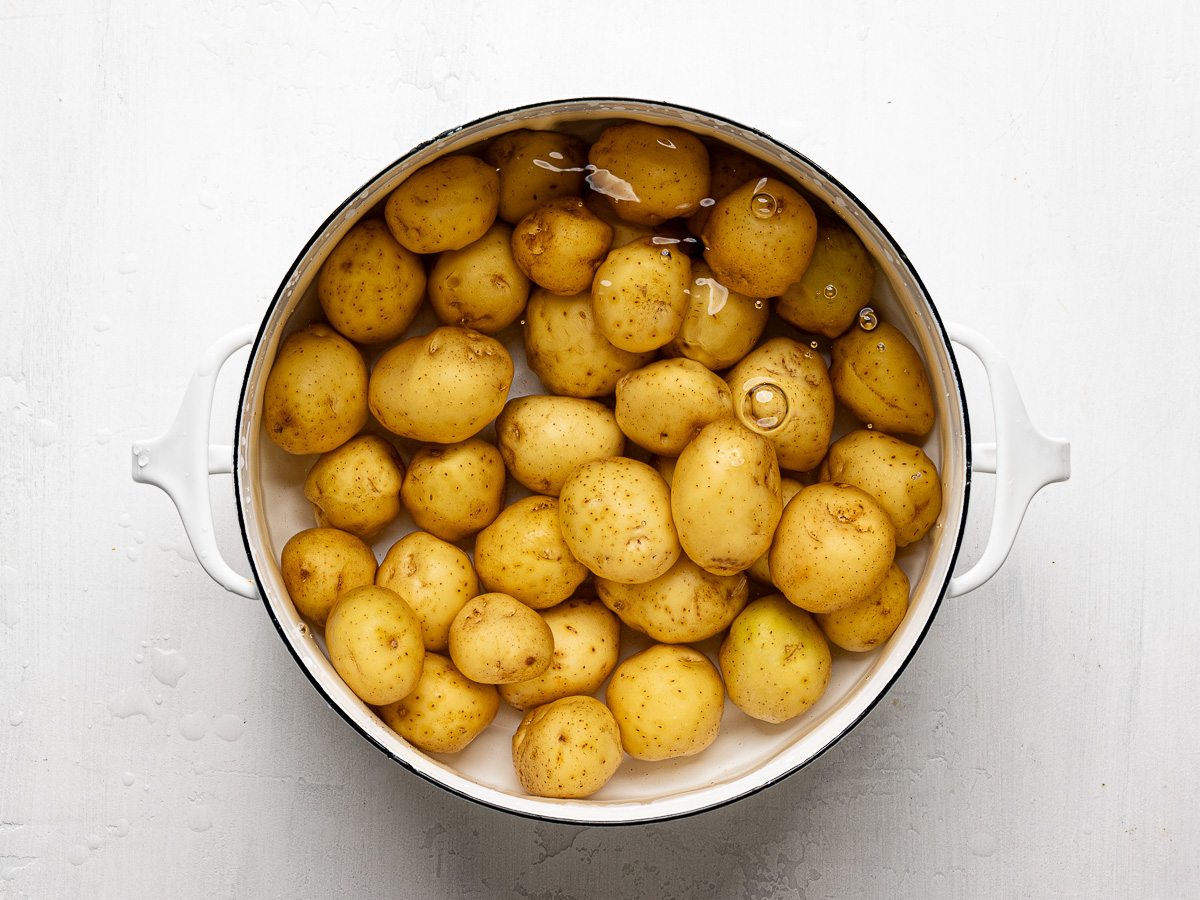 Boiled baby potatoes in a large pot ready to be smashed for TikTok-inspired potato salad.