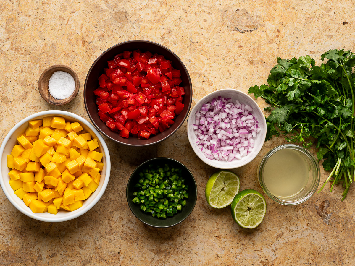 Ingredients for mango pico de gallo prepared in bowls.