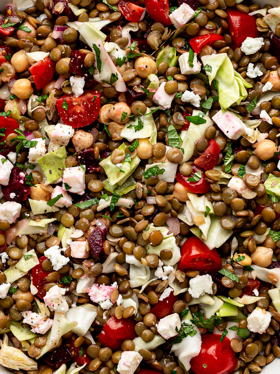 Close-up of green lentil salad tossed with crunchy vegetables and zesty dressing, perfect for meal prep or plant-based lunches.