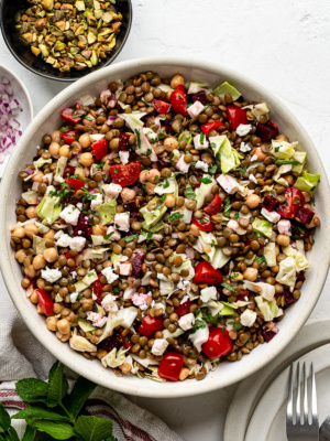 Colorful lentil chopped salad with cabbage, tomatoes, and herbs in a serving bowl — a healthy, make-ahead summer salad.