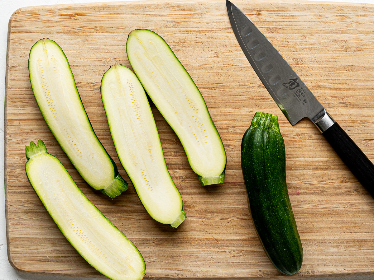 Zucchini cut into planks on a cutting board.