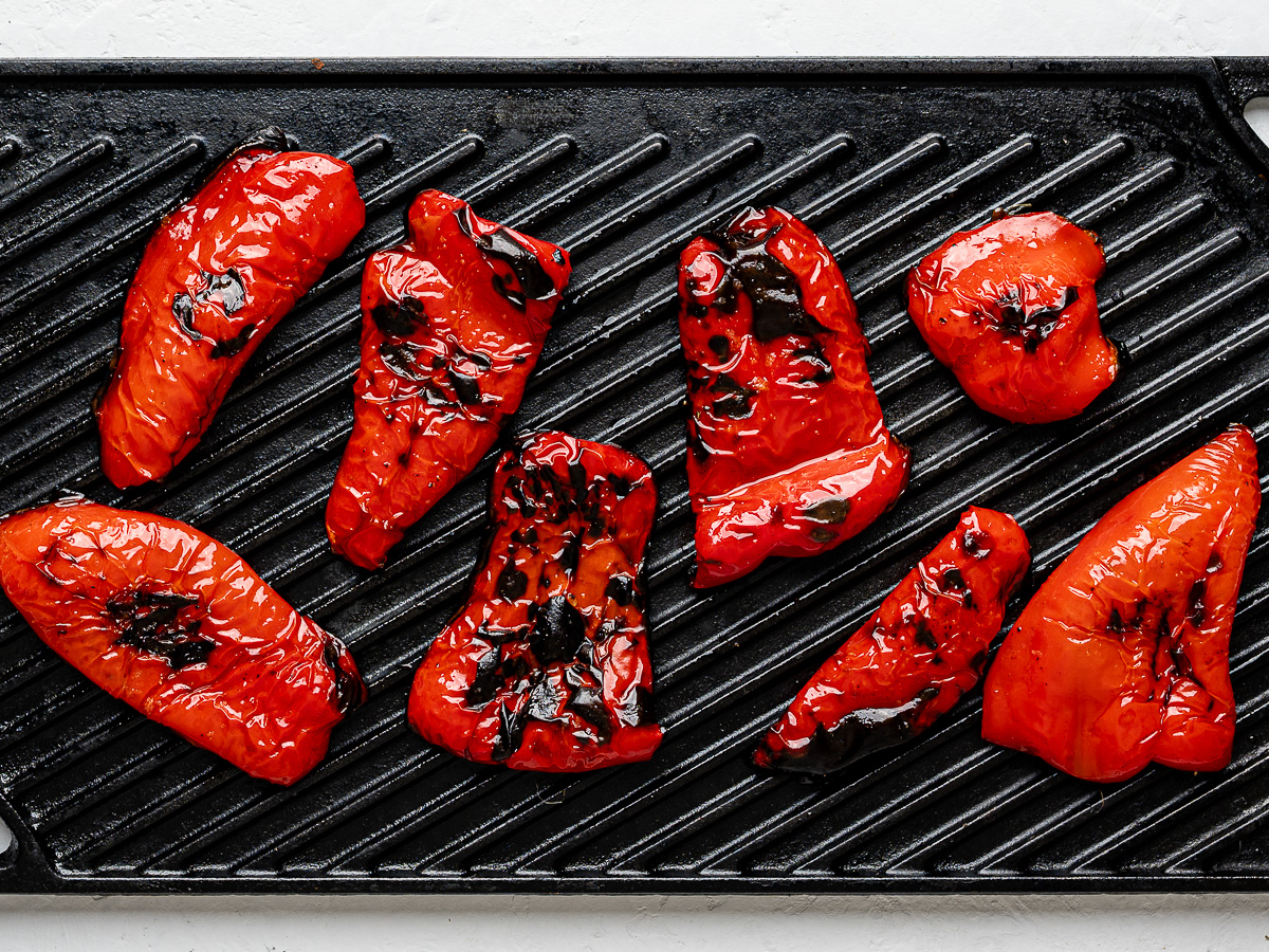 Grilled red peppers on a grill pan.