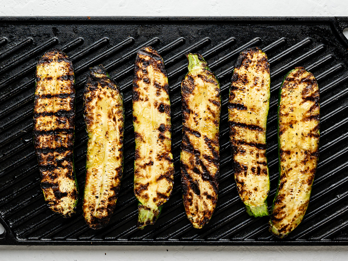 Grilled zucchini planks on a grill pan.