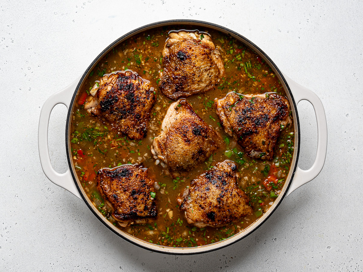 Chicken pieces nestled in liquid before baking.