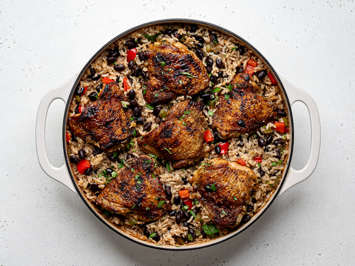 Baked chicken and rice with black beans in skillet.