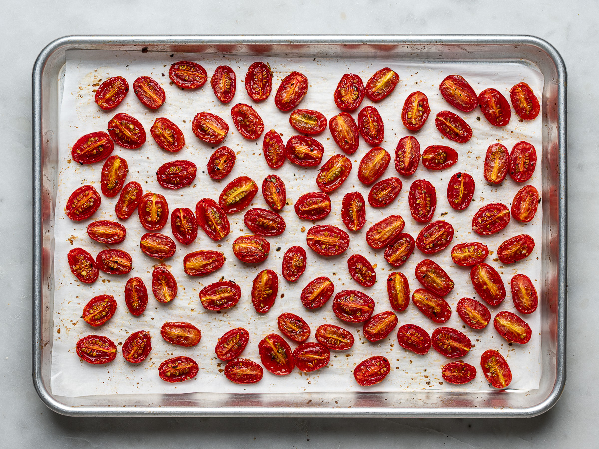 Roasted cherry tomatoes on baking sheet.