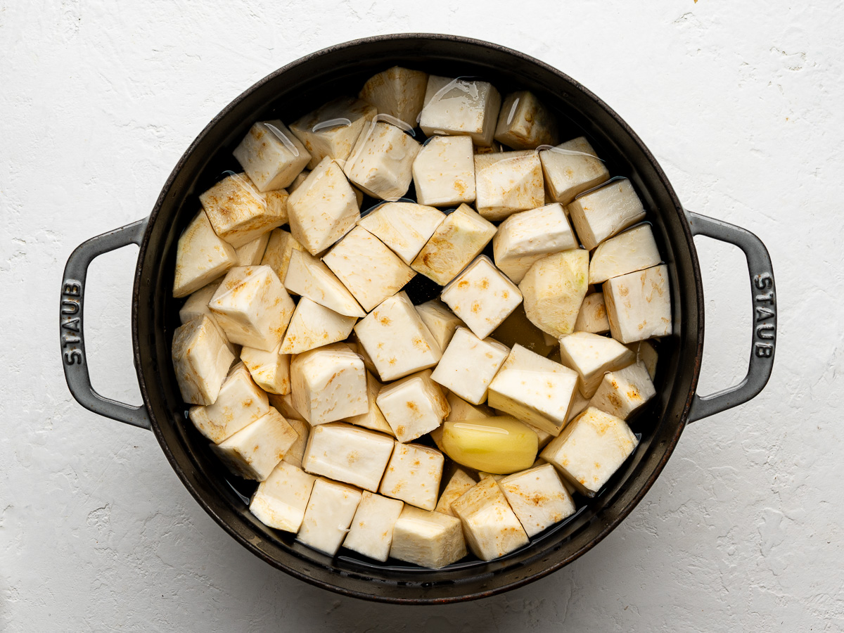 Cubed celeriac and potato in large pot with water ready to be boiled.