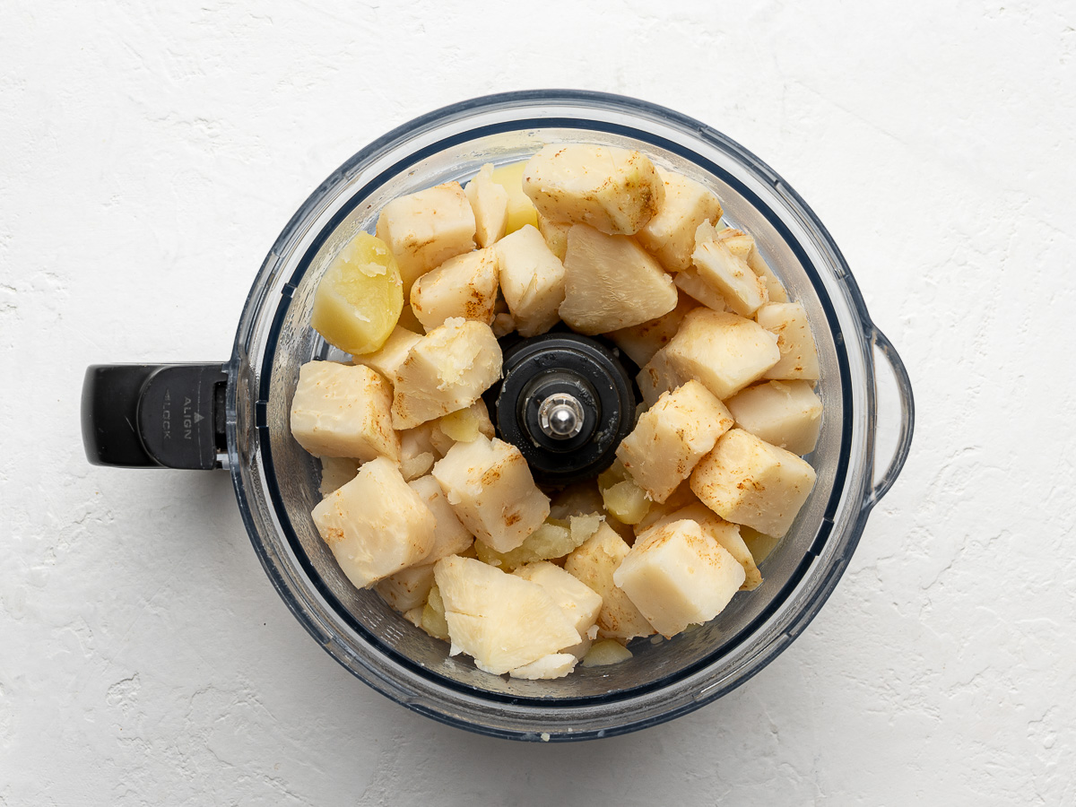 Cooked celeriac cubes in food processor.