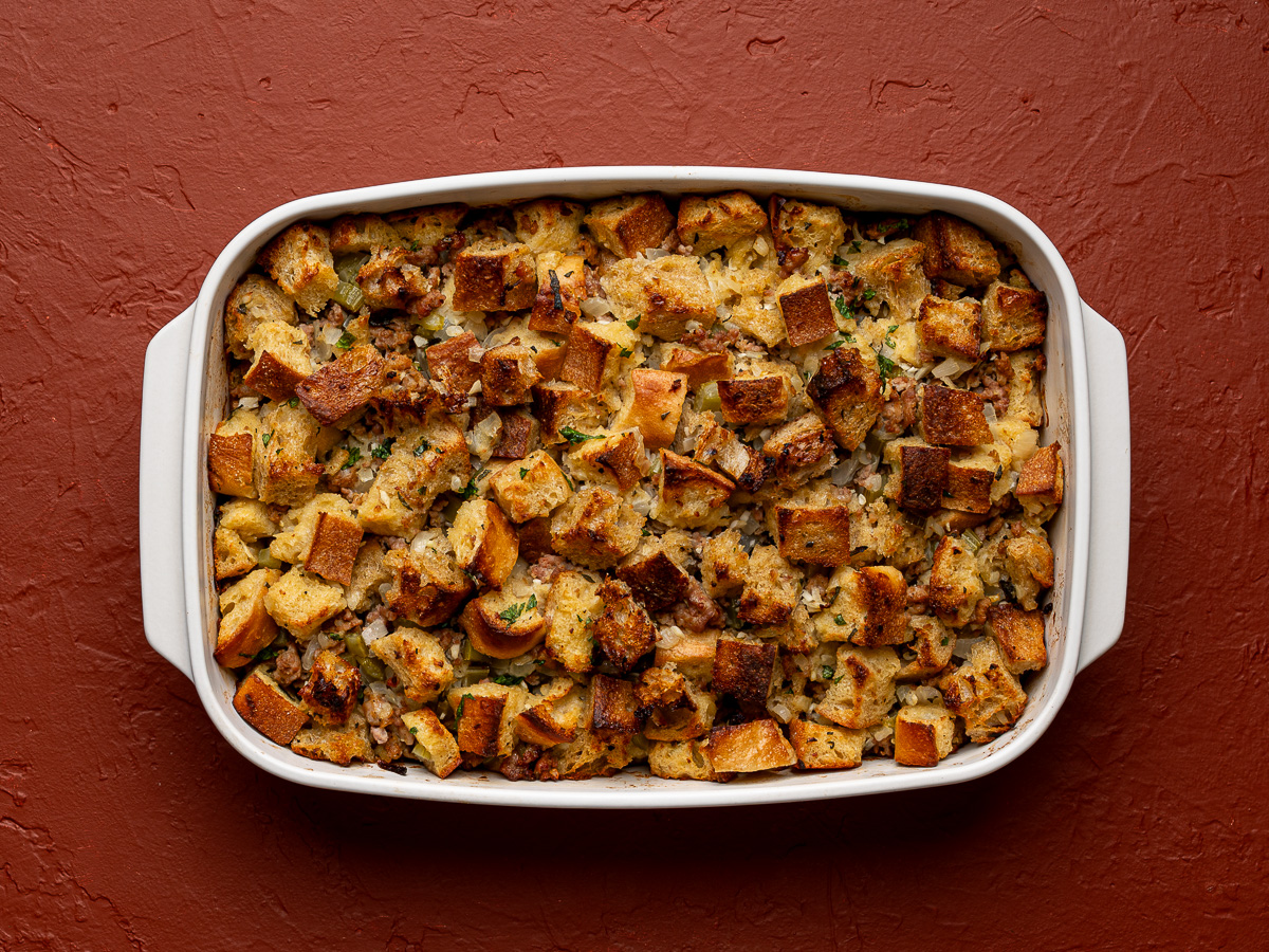 Baked stuffing in white baking dish with crispy topping.