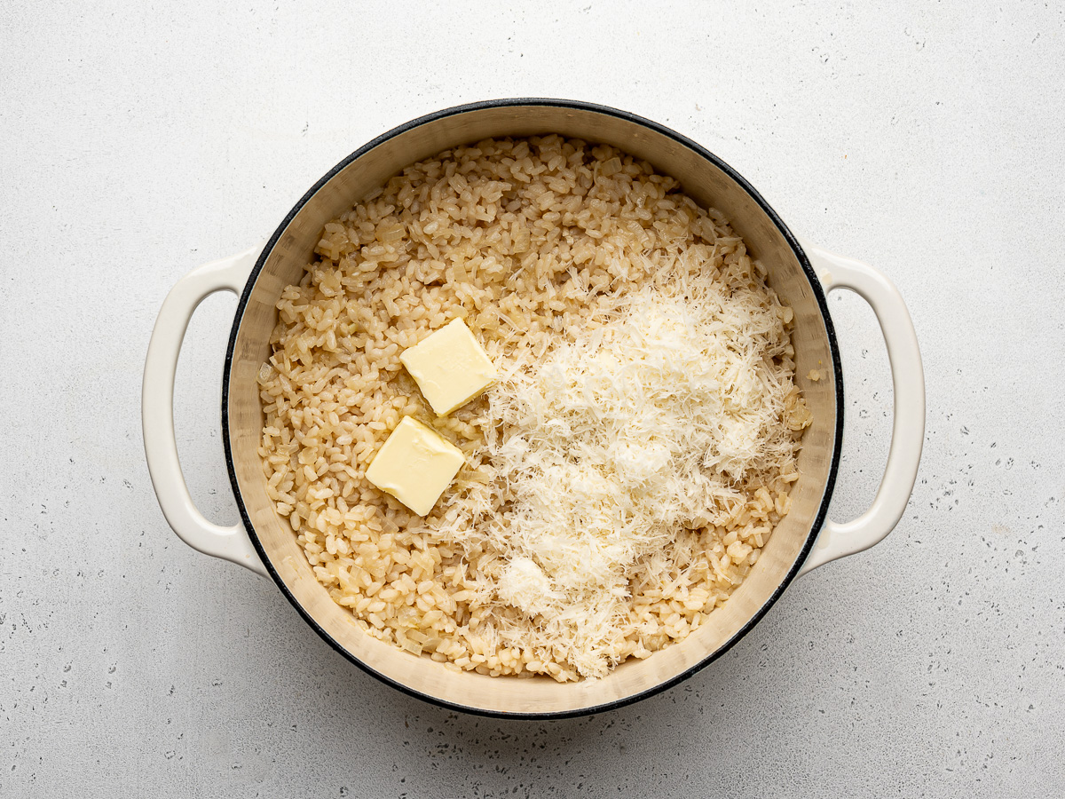 Cooked risotto-style rice in dutch oven with butter and parmesan.