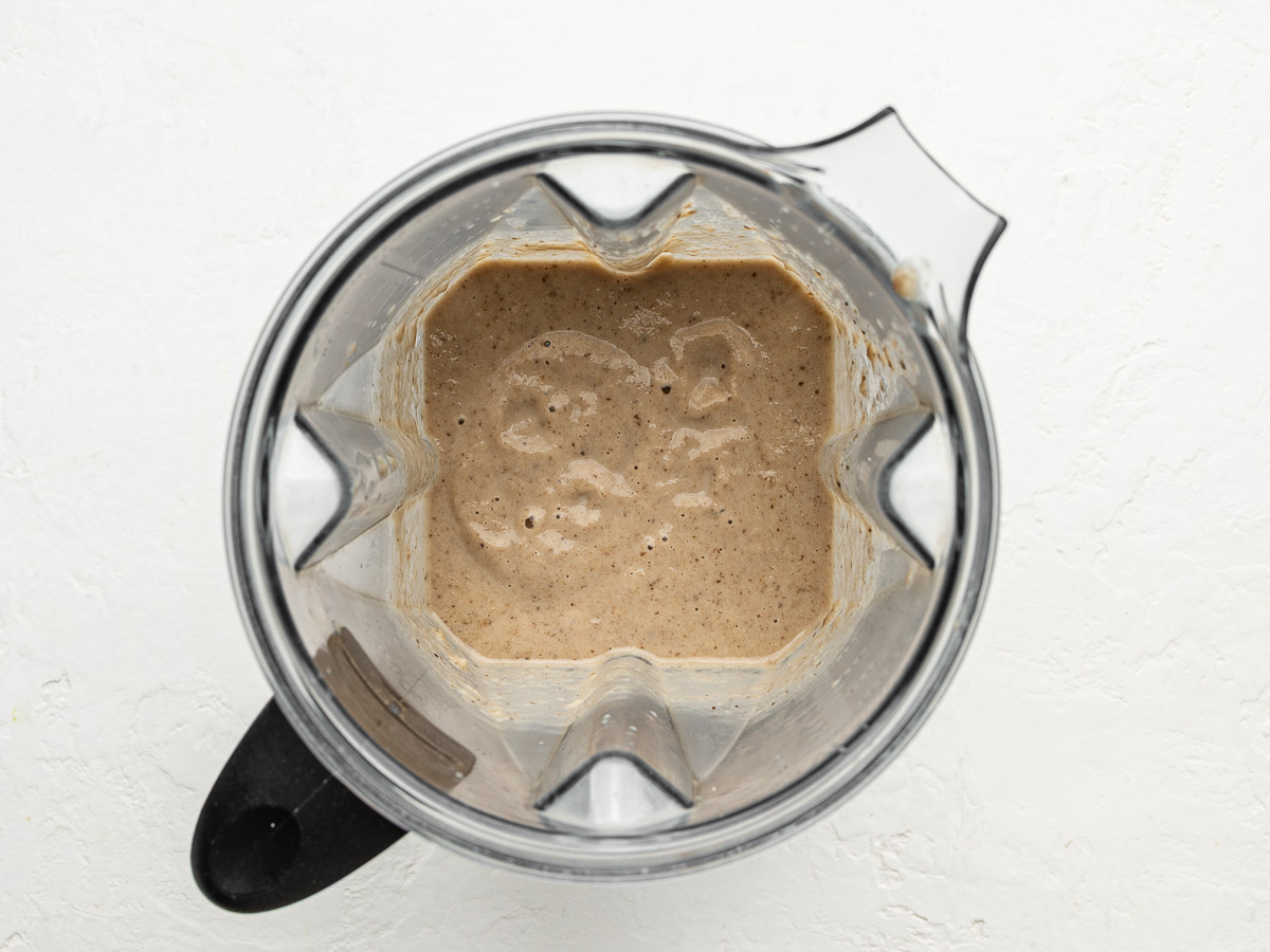Blending creamy mushroom soup in a blender until smooth