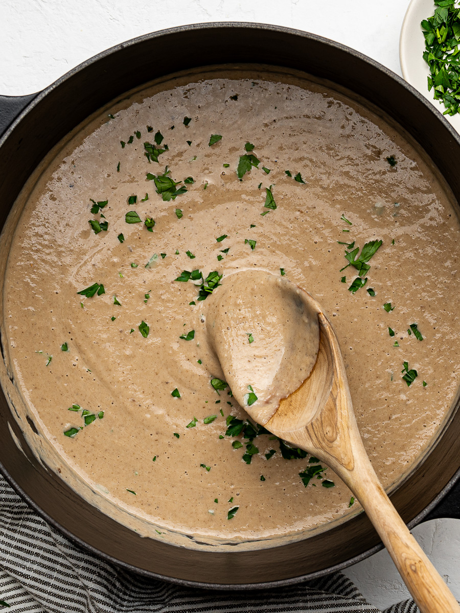 Homemade creamy mushroom soup in a Dutch oven ready to serve.
